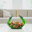 Decorative glass bowl with colorful flowers on a table in a living room setting, featuring the brand 'FIGUR'.